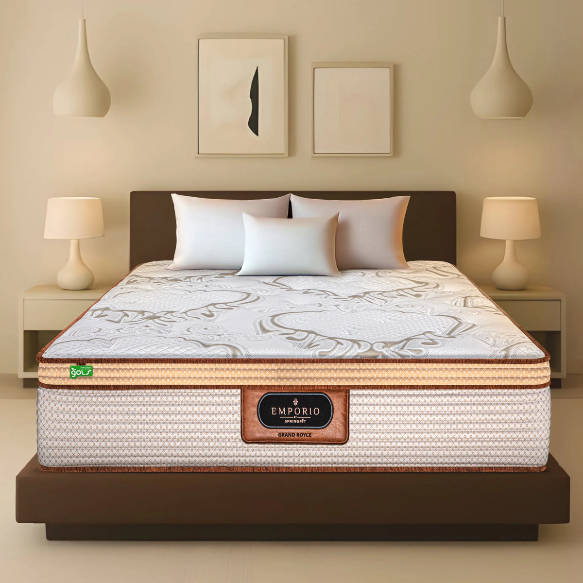 Front view of Springfit Emporio Grand Royce mattress with ornate white and gold fabric top on dark platform bed with white pillows in a warm beige bedroom